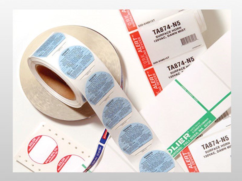 Buyer reviewing label materials beside containers